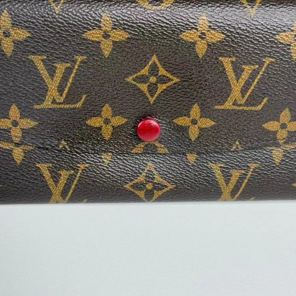 Louis Vuitton Monogram Canvas Wallet with Classic Design and Red Pin Detail